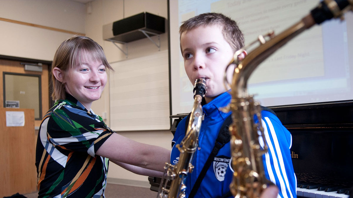 Student giving saxophone lessons