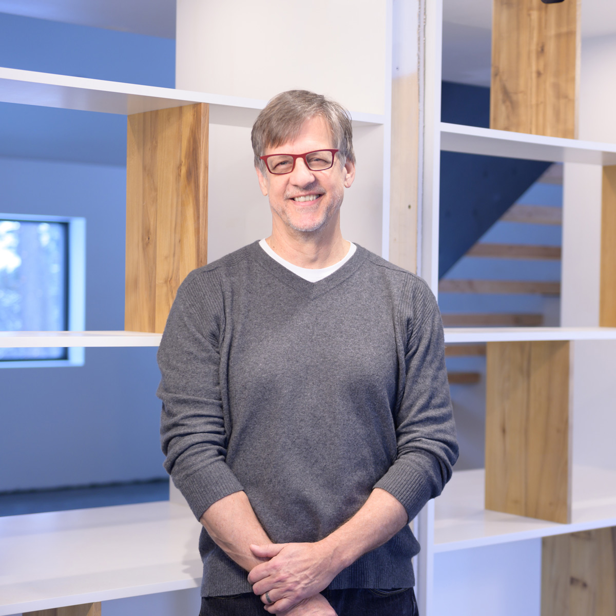 Robert Zimmer stands next to the shelves.