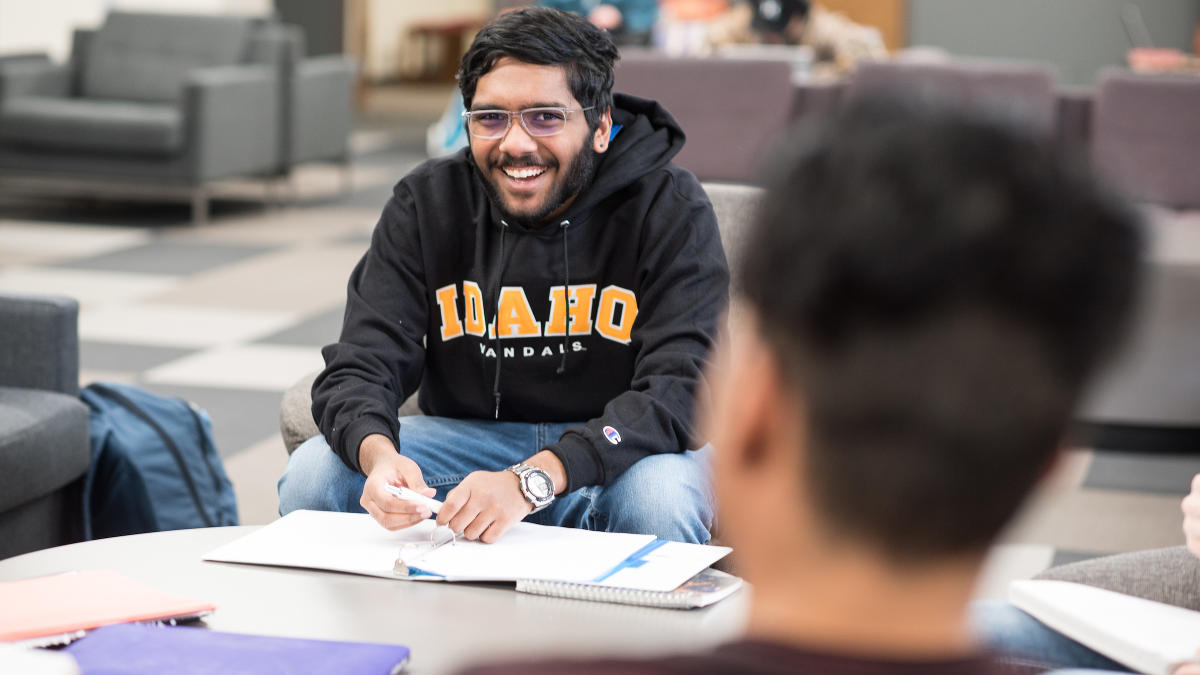 Students studying at a table in the library