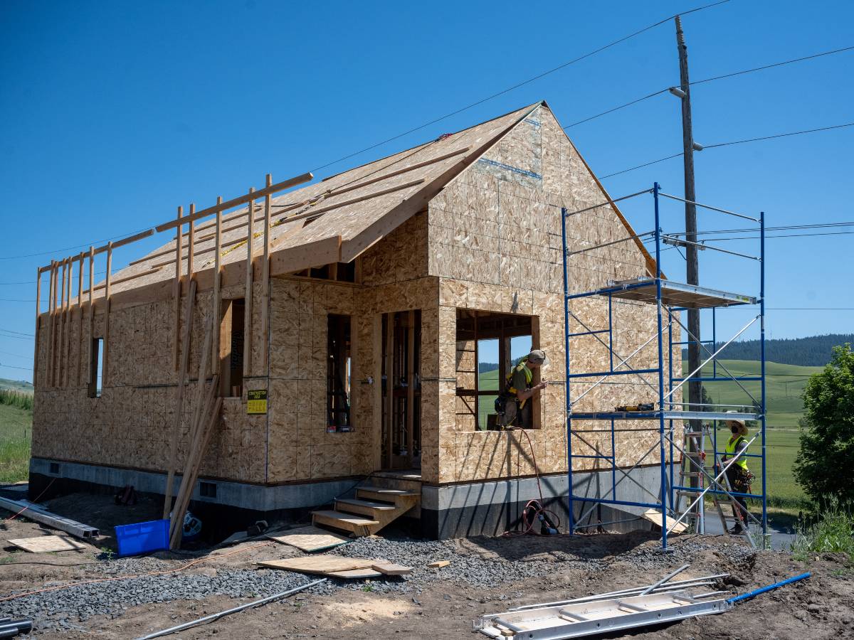 Picture of house with worker in window.