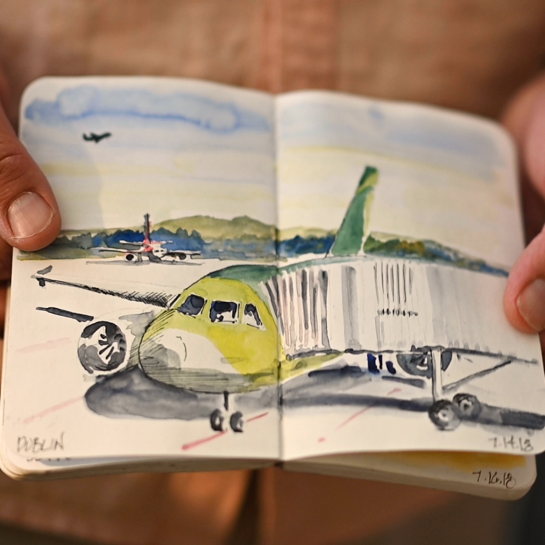 A sketch of an airplane parked at a jetway.
