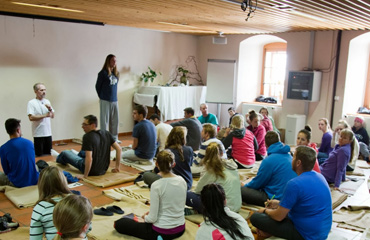 Alex Baldwin helps lead the students in restorative yoga positions inside the hospice.