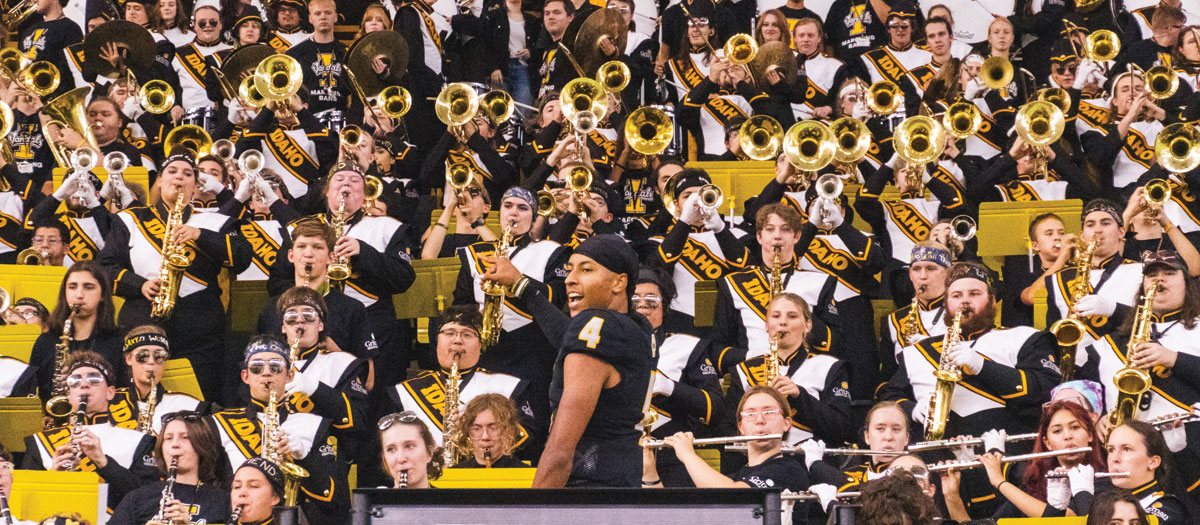 A wide shot showing the Vandal Marching Band in the stands of the Kibbie Dome.