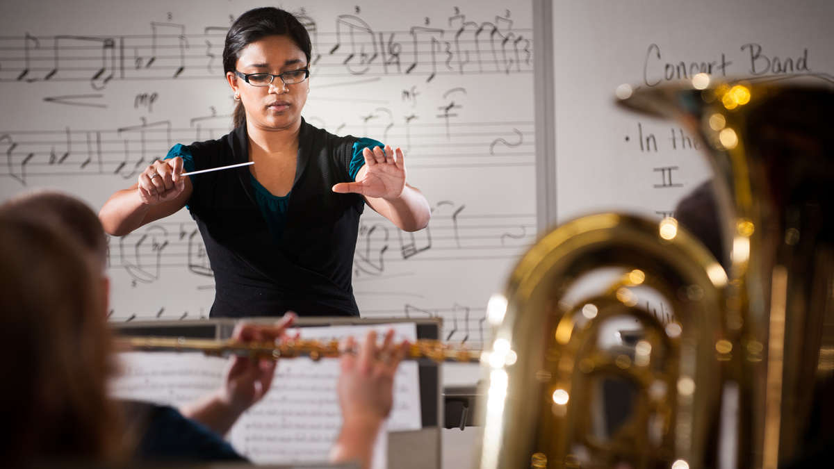 Corinne Smith conducts students at a rehearsal.