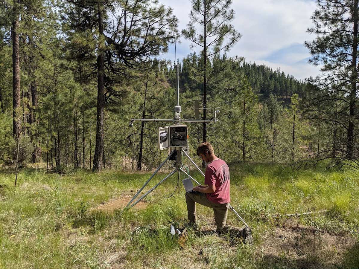 Clayton Christensen checks and downloads data from an automated weather station.