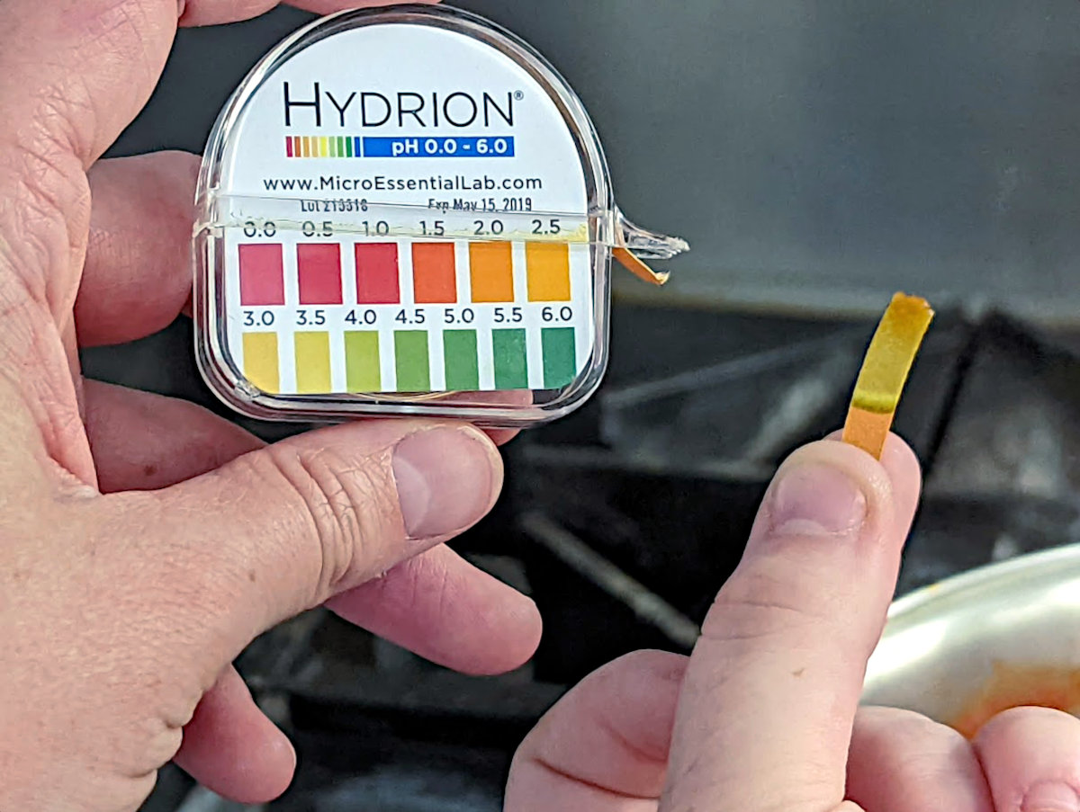 Picture of acid test on paper and plastic acidity scale.