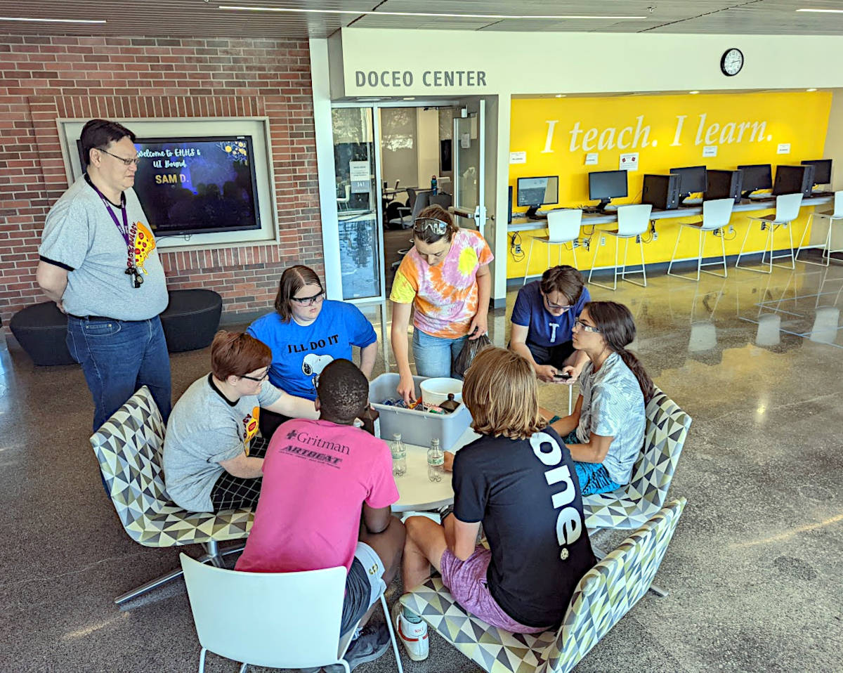 Students sitting at round table.