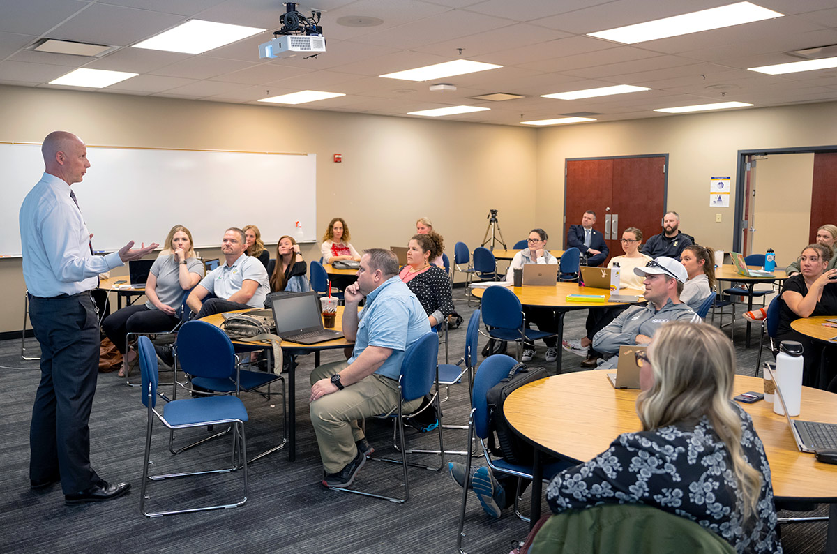 Classroom instructor speaks in front of class