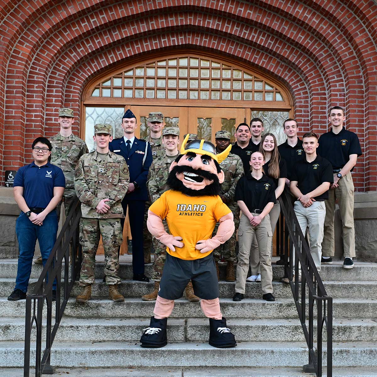 Joe Vandal poses with members of the military on the northern steps of the Administration Building.