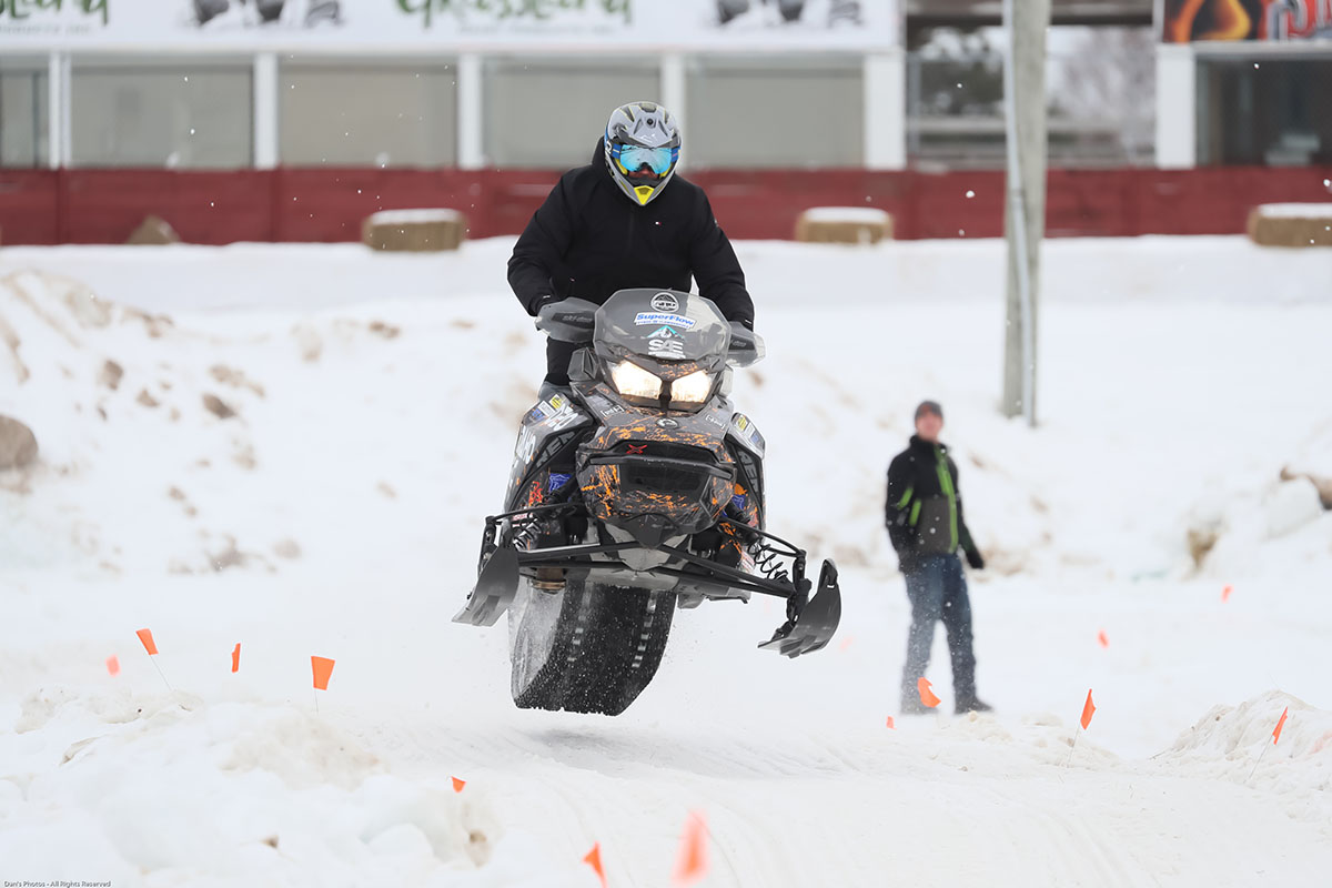 Person riding snowmobile in the air
