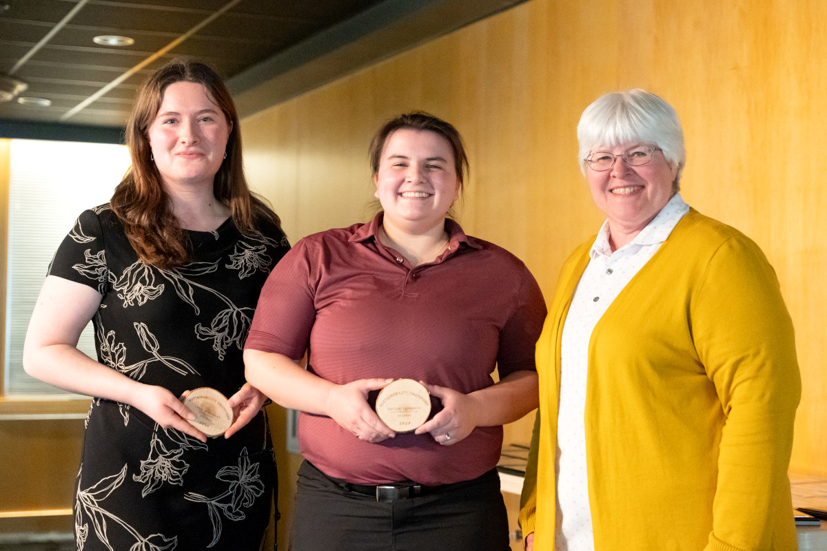 people posing with award in hands