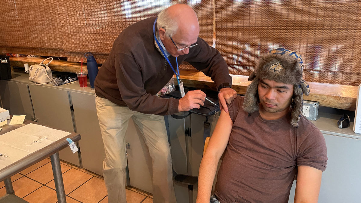 Medical doctor administers injection.