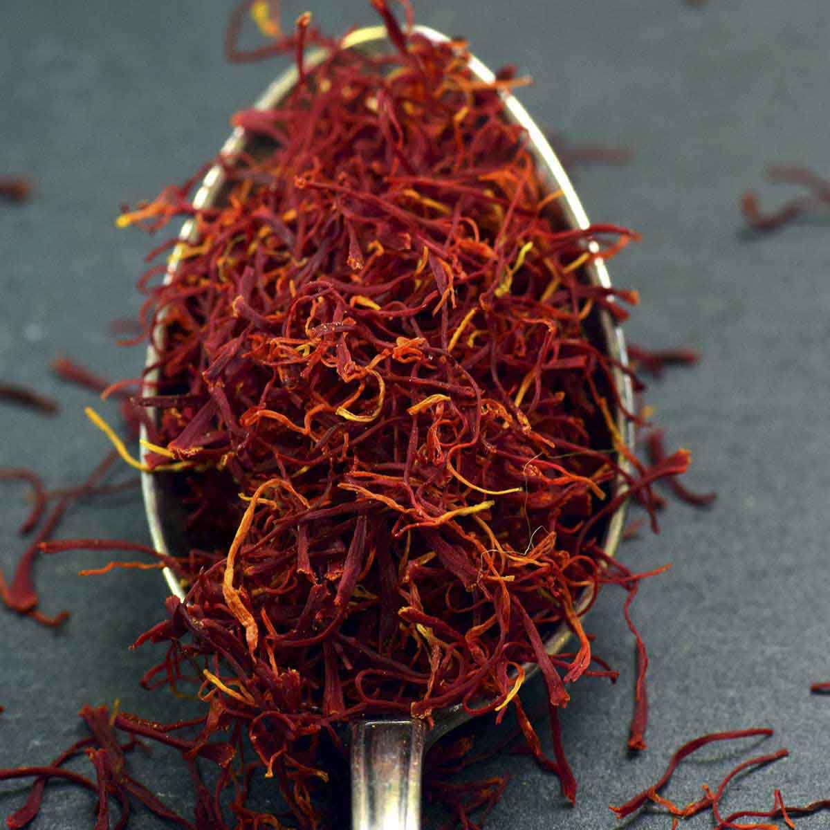 Spoonful of red and orange saffron filaments.