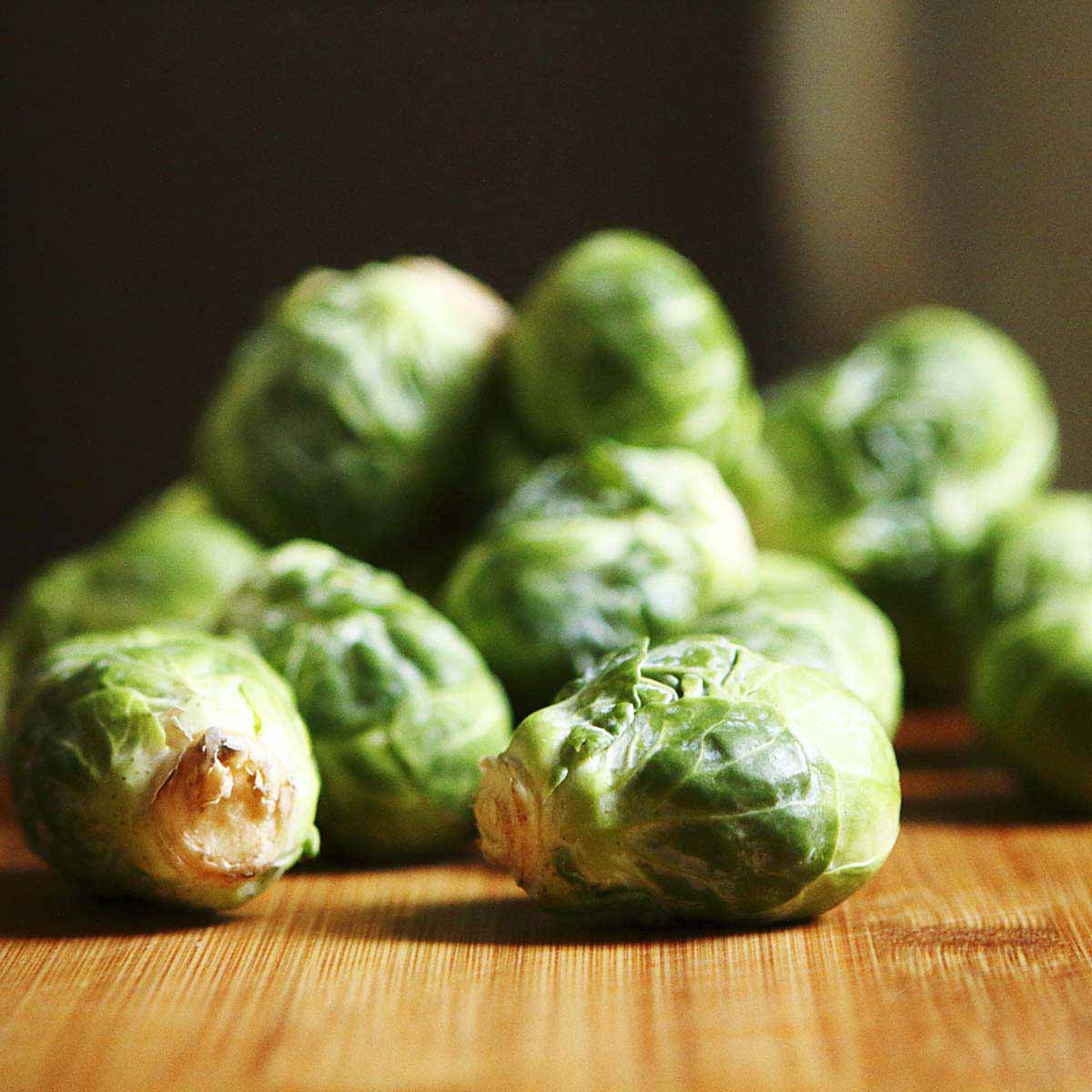 Brussel Sprouts tumble over counter top.