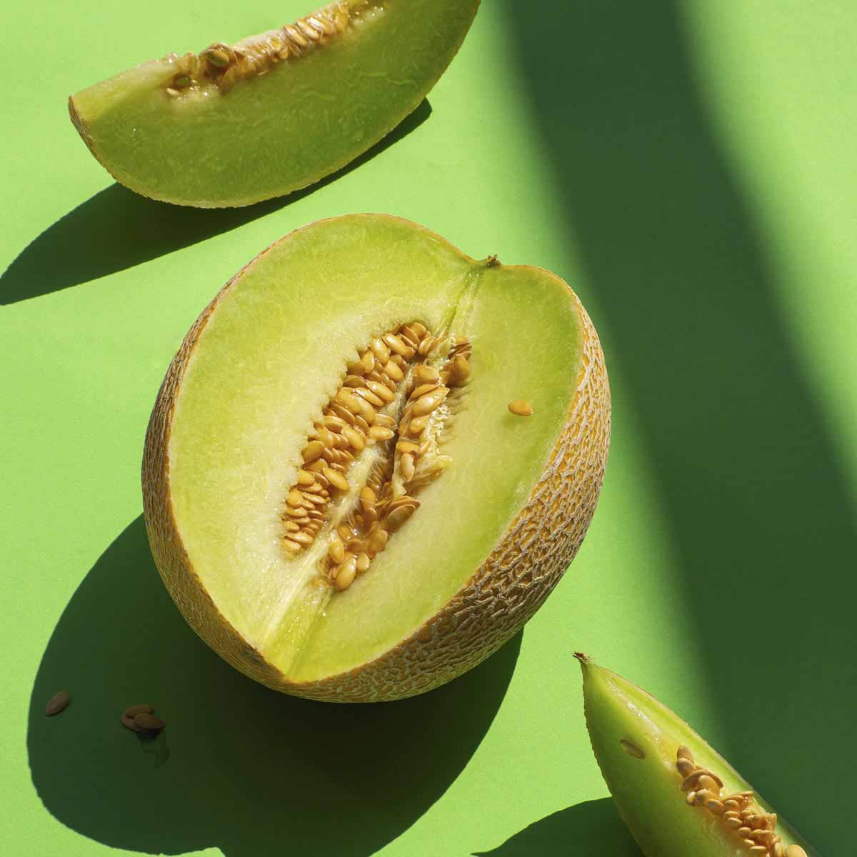 Ripe honey dew sliced and showing green meat.