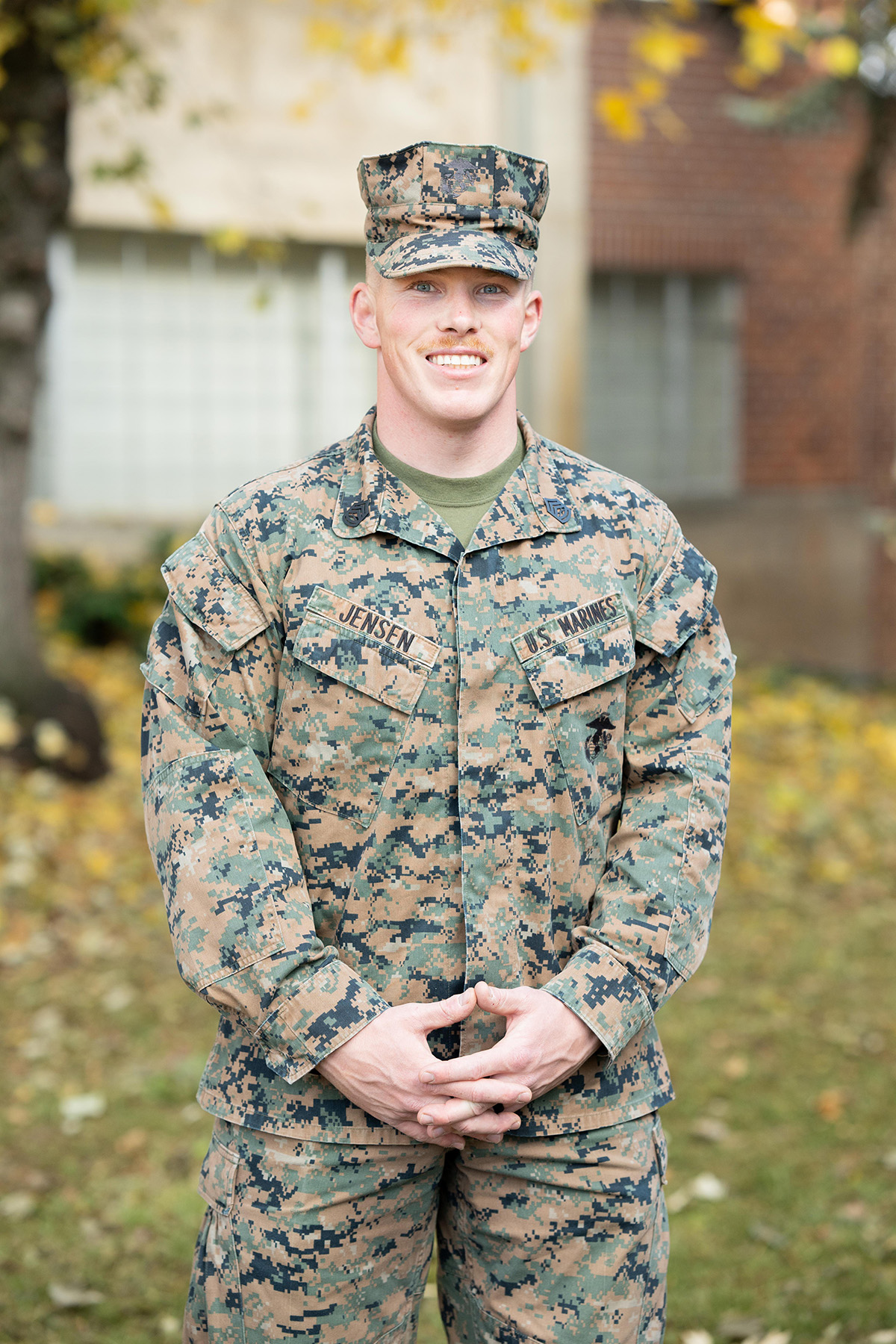 Man wearing battle dress uniform stands in Albertson’s Building