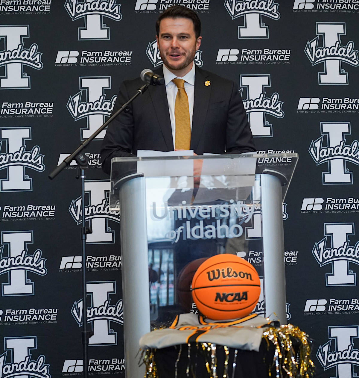 Basketball coach behind podium.