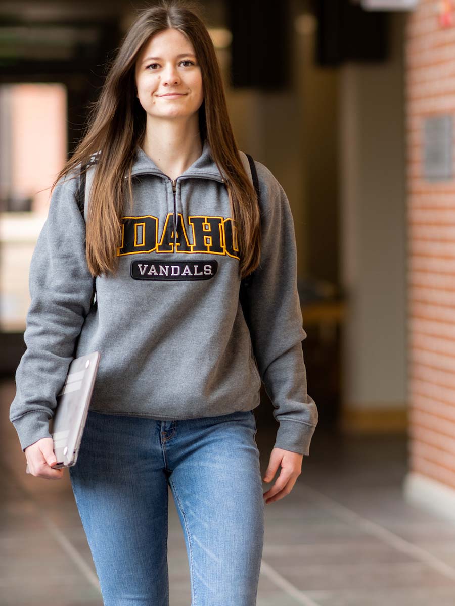 Savanna Pagel walks through the Albertson Building atrium. She carries her laptop, ready to meet up with the research team.