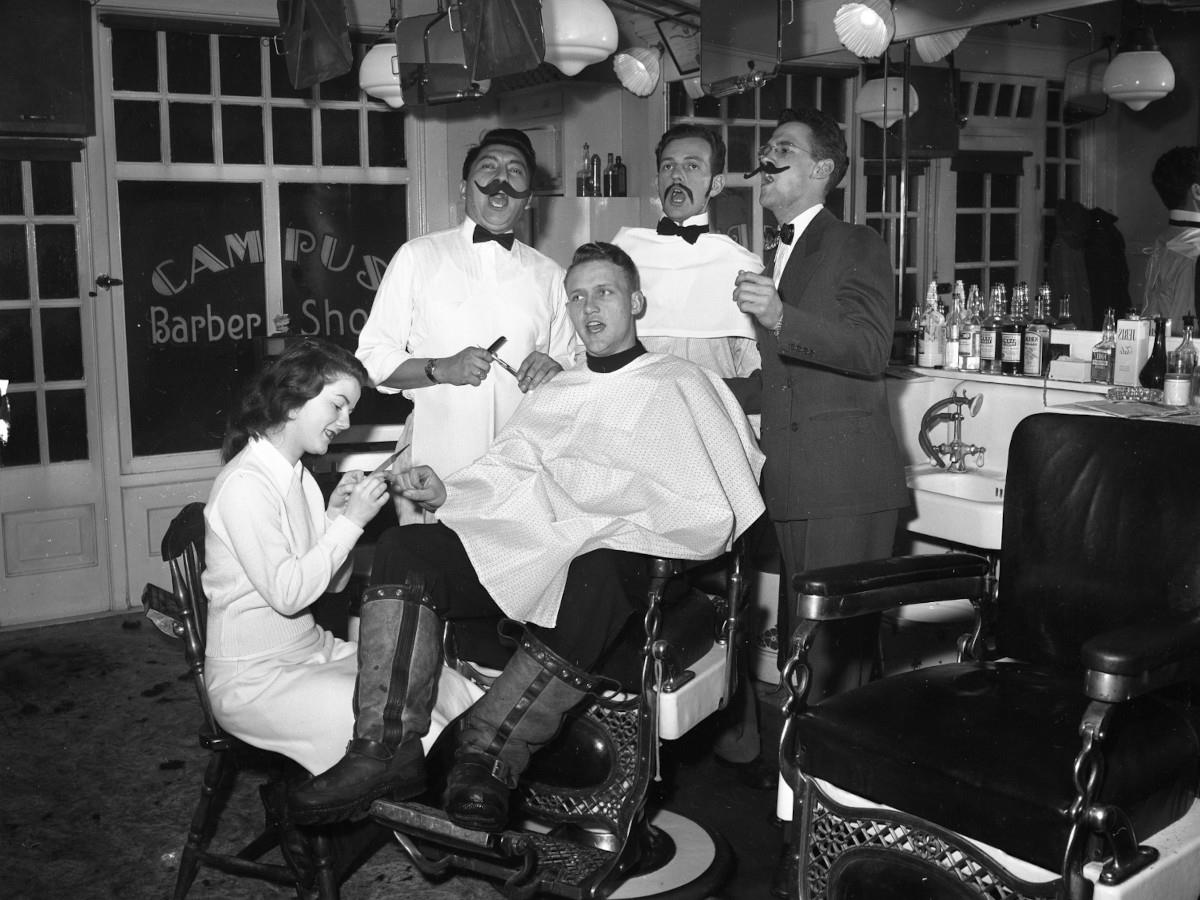 Jim and Louise McClure in a barber shop with fellow Vandaleers
